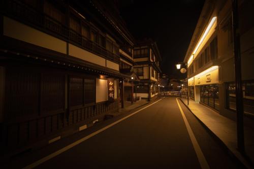 an empty street at night with lights on at Private hot-spring Villa in Kusatsu #projector in Kusatsu