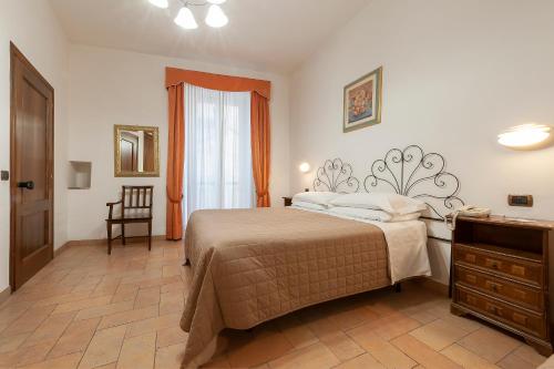a bedroom with a bed and a dresser and a window at Hotel Sole in Assisi