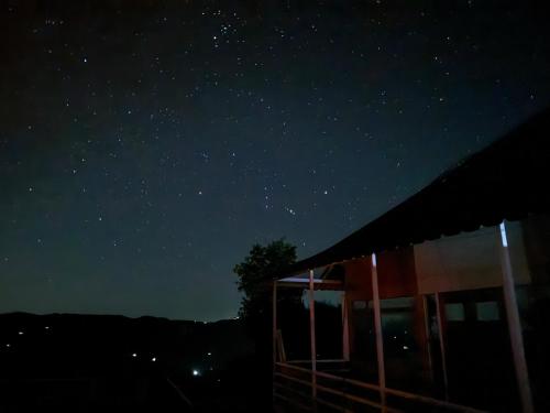 a starry night with a house in the foreground at Wanderlust Mukteshwar in Mukteswar