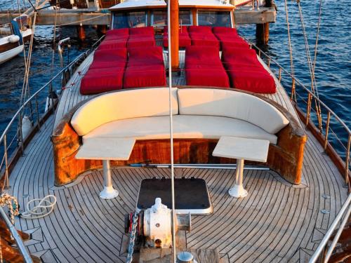 a large boat with red cushions on the deck at Bodrum Private Boat Tours -Daily -Yacht Tours Bodrum in Bodrum City