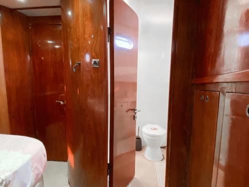 a bathroom with a toilet and a wooden cabinet at Bodrum Private Boat Tours -Daily -Yacht Tours Bodrum in Bodrum City
