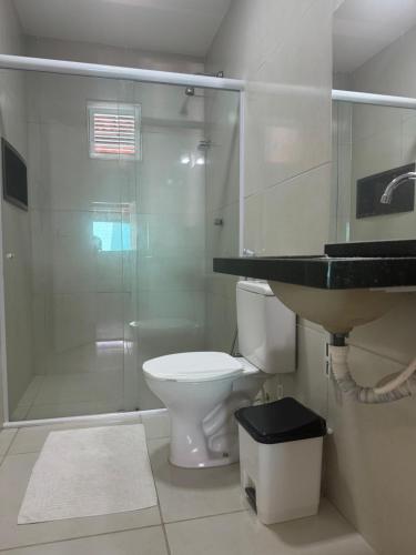 a bathroom with a shower and a toilet and a sink at House Beach Canoa in Canoa Quebrada