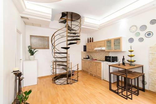 a kitchen with a spiral staircase in a room at Traditional Vintage House Plaka, Athens Center in Athens