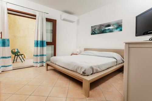 Säng eller sängar i ett rum på Fronte Mare Capo Testa