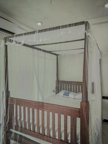 a bedroom with a canopy bed in a room at River Relax Villa in Ahangama