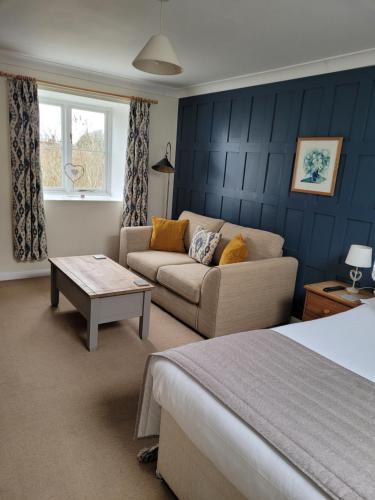 a living room with a bed and a couch at Pear Tree House B&B in Pickering