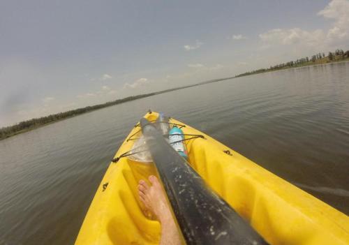 a person in a kayak on a body of water at Lakeside Fish Farm in Bugesera