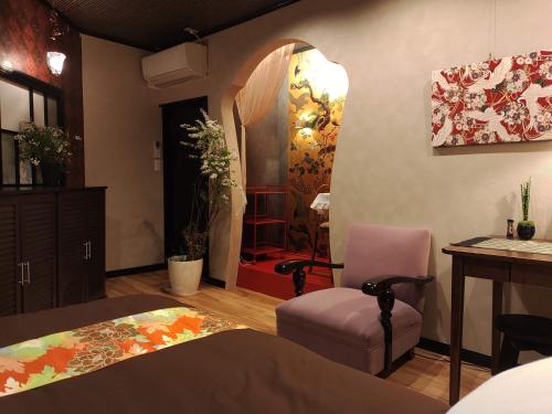 a bedroom with a bed and a chair and a table at 木香Mokkoh Modern Japanese style room by train15 minutes to Tokyo Station in Tokyo