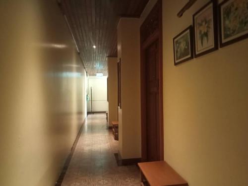 a hallway with a long hallway with a table and a hallway sidx sidx at Sripat Guesthouse SHA Extra Plus in Chiang Mai