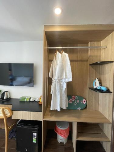 a closet with a white robe hanging in it at JOYCE HOUSE in Quy Nhon
