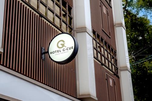 a hotel sign on the side of a building at HOTEL G-CUE 大阪谷町 in Osaka