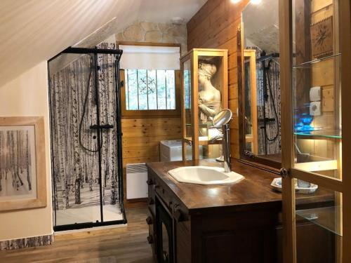 a bathroom with a sink and a mirror at La Boissette d’en O in Montgenèvre