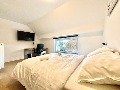 a bedroom with a large bed and a window at Il Casolare in Beersel