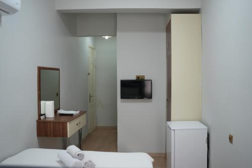 a hotel room with two beds and a mirror at Grand Clover Otel in Seyhan