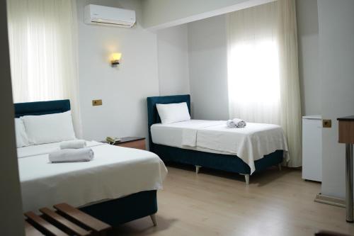 a room with two beds and a window at GRAND CLOVER otel in Seyhan