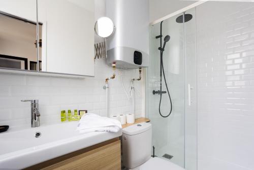 a bathroom with a shower and a toilet and a sink at Stunning 1-bedroom apartment in a vibrant neighborhood of Montmartre in Paris