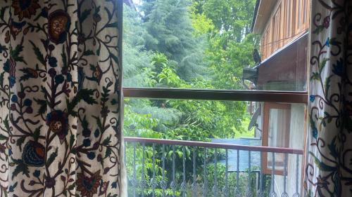 an open window with a view of a garden at Zebervan Retreat in Srinagar