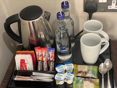 a shelf with food and drinks and a coffee maker at Stone House Hotel ‘A Bespoke Hotel’ in Stone