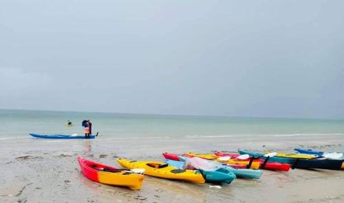 a group of kayaks sitting on a beach at BEACH FRONT modern room + Free hi speed Wi-Fi in Ban Chak Phai