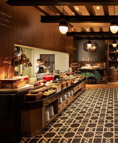 a large kitchen with a chef preparing food in it at Avista Grande Phuket Karon - MGallery in Karon Beach