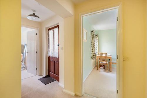 a hallway with a door leading to a dining room at Lovely Town Centre 1 Bed Nr Country & River Walks 