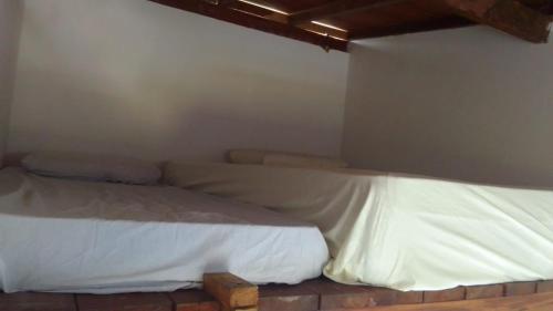 Giường trong phòng chung tại Chalé Macassa