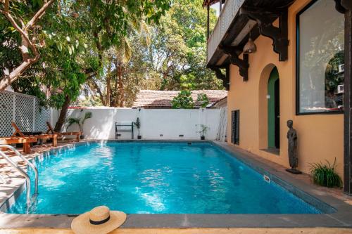 a swimming pool in the backyard of a house at The Secret Cove by Stay ALYF, Baga in Baga