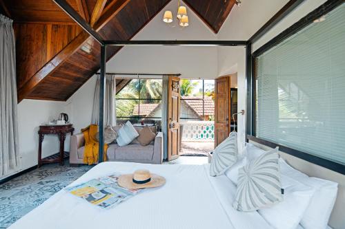 a bedroom with a bed with a hat on it at The Secret Cove by Stay ALYF, Baga in Baga