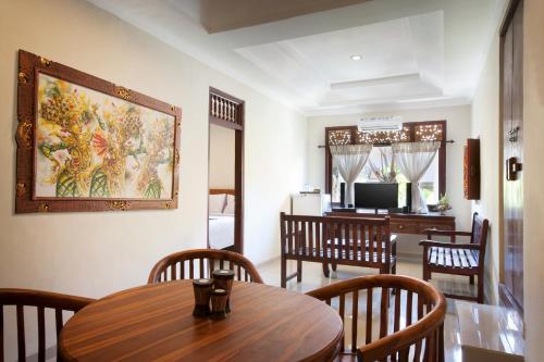 a dining room with a table and chairs at Nesa Sanur Bali in Sanur