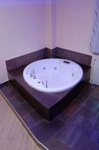 a bath tub in a bathroom with a tile floor at La dimora del capitano in Quattordio