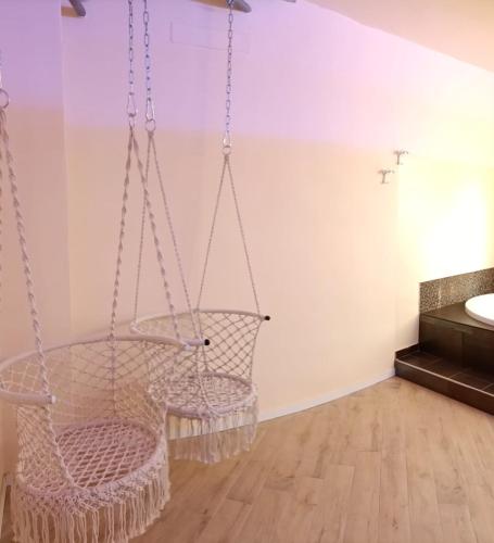 a swinging chair in a bathroom with a sink at La dimora del capitano in Quattordio