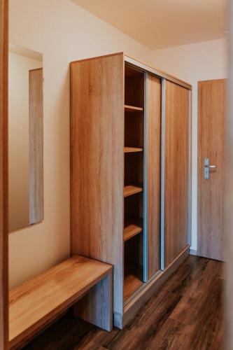 a room with a closet with wooden shelves at penzion ROSETA in Radějov