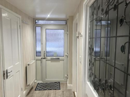 a hallway with a white door and a window at Remarkable 3-Bed House in Basildon in Basildon