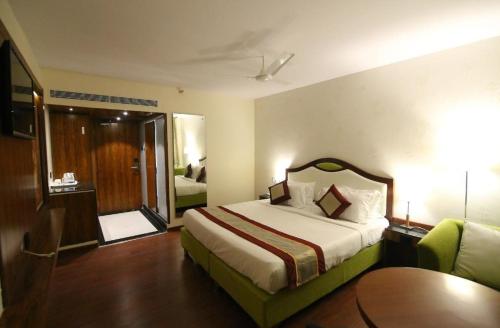 a hotel room with a bed and a sliding glass door at HOTEL BLACK & WHITE in Visakhapatnam