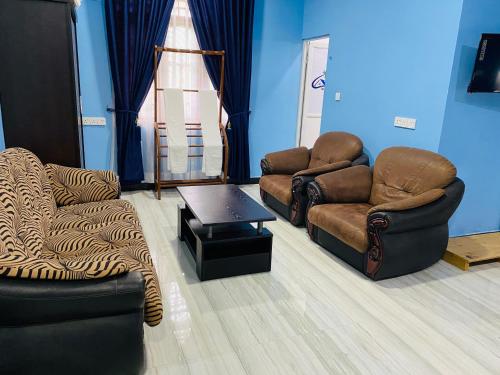 a living room with two chairs and a table at Nilaveli Hybrid Holiday Hotel in Nilaveli
