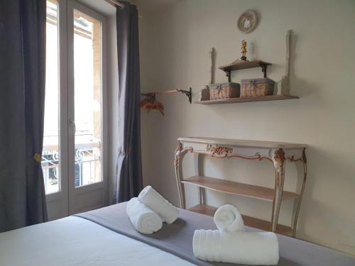 a bedroom with a bed with towels on it at À l'époque in Sarlat-la-Canéda