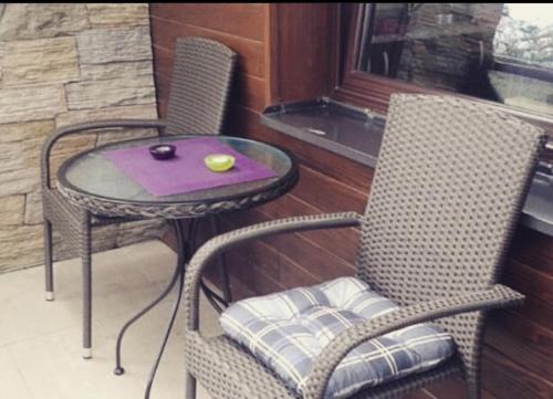 a table and two chairs and a table and a table and a table at Apartman Bianca in Palisad