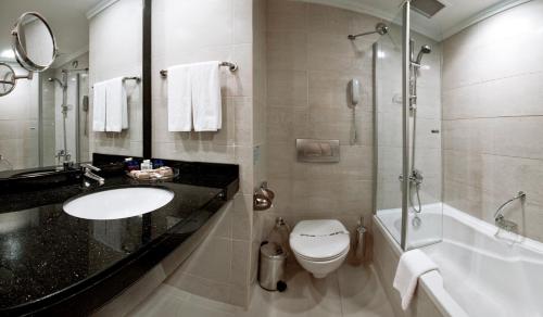 a bathroom with a sink and a toilet and a shower at Liberty Hotels Lara in Lara