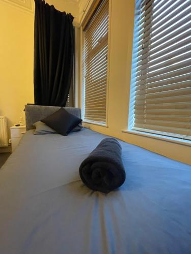 a bedroom with a bed with a hat on it at Dinorwic Lodge in Liverpool