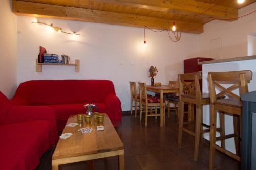 a living room with a red couch and a table at U Rožmberka Třeboňsko in Lužnice