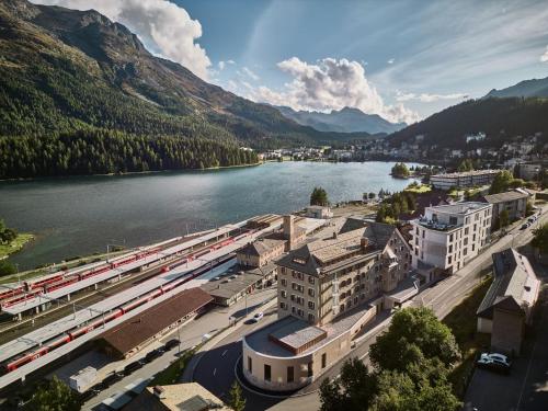 uma cidade ao lado de um rio com uma montanha em Hotel GRACE LA MARGNA ST MORITZ em St. Moritz