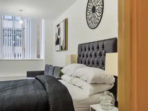 1 dormitorio con 1 cama con cabecero de cuero negro en Pass the Keys Chic Strand Studio, en Liverpool
