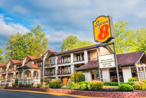 a sign in front of a hotel with a fast food restaurant at Super 8 by Wyndham Downtown Gatlinburg at Convention Center in Gatlinburg