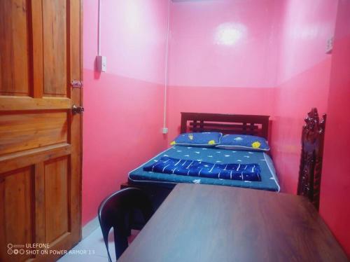 Zimmer mit einem Bett und einem Tisch in der Unterkunft Couple Room Pink RODE WAY HOUSE SPACE RENTAL in Pico