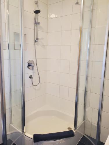 a shower in a bathroom with a glass door at Ferienwohnung in Schlanders in Silandro