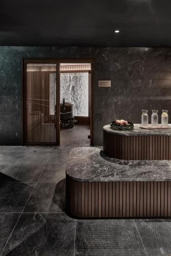 a lobby with a table with vases on it at Hotel GRACE LA MARGNA ST MORITZ in St. Moritz