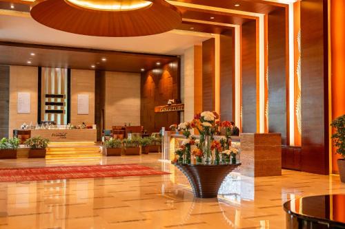 a lobby of a hotel with a vase of flowers at Hyatt Pune in Pune
