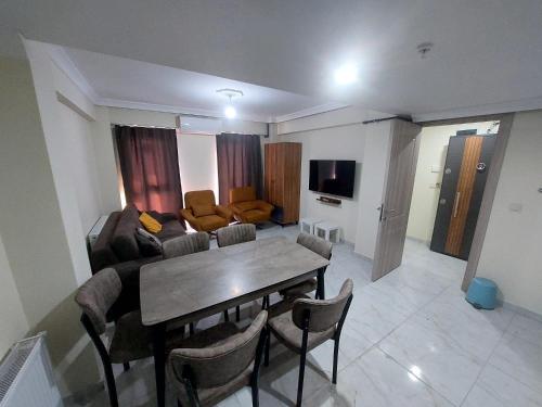 a living room with a table and a couch at NOOR APARTMENTS in Bursa
