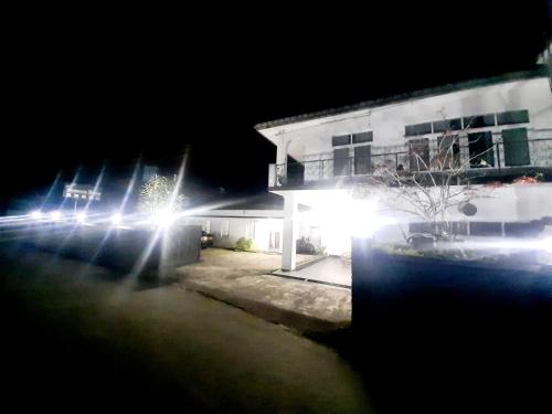 a group of cars parked in front of a building at night at Sapu's Mountain breeze Nuwara Eliya in Nuwara Eliya