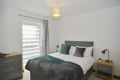 a bedroom with a large bed and a window at Stylish, 2-bedroom flat, Central Southend Flat, 11th floor in Southend-on-Sea